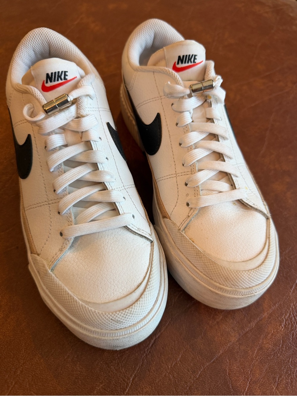 Nike White Leather Low-Top Sneakers with Black Swoosh and Red Tongue Logo